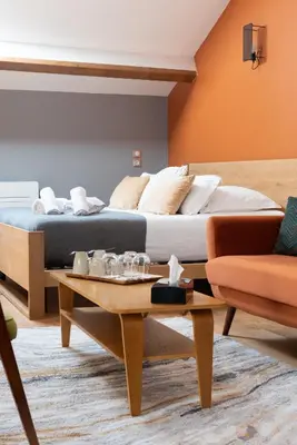 a hotel room with a bed and a coffee table at La Maison d'en Bas des Seigneurs in Cucuron