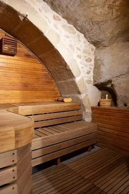 a sauna with wooden benches in a stone building at La Maison d'en Bas des Seigneurs in Cucuron
