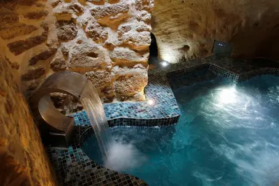 an overhead view of a swimming pool with a waterfall at La Maison d'en Bas des Seigneurs in Cucuron