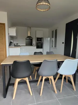 a large wooden table with four chairs and a kitchen at L'Oustau de Laëtitia Animaux bienvenus in Fontaine-de-Vaucluse