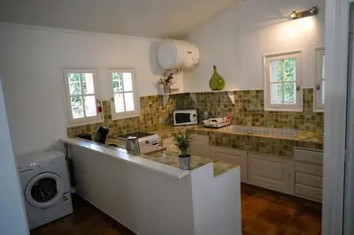 a kitchen with a sink and a counter top at Villa Bois Romay dans le Luberon avec piscine, tennis et pétanque. in La Bastide-des-Jourdans