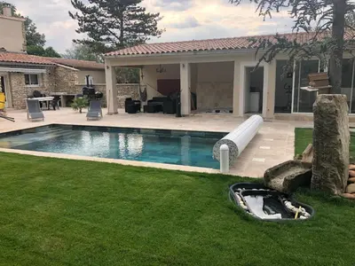 a swimming pool with a water slide in a yard at Au milieu des Piboules de Provence. in LʼIsle-sur-la-Sorgue