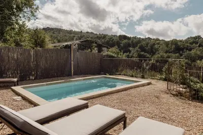 a swimming pool in a backyard with a fence at GITE LE TILLEUL in Mormoiron