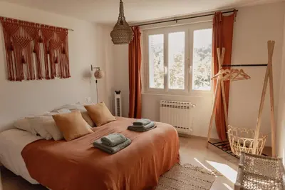 a bedroom with a large bed and a window at GITE LE TILLEUL in Mormoiron