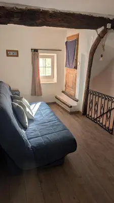 a bedroom with a blue bed and a window at La Carriera, petite maison Provençale sud Ventoux, climatisée in Bédoin