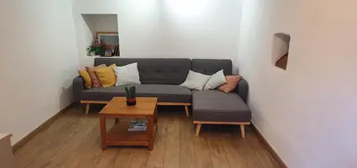 a living room with a couch and a table at La Carriera, petite maison Provençale sud Ventoux, climatisée in Bédoin