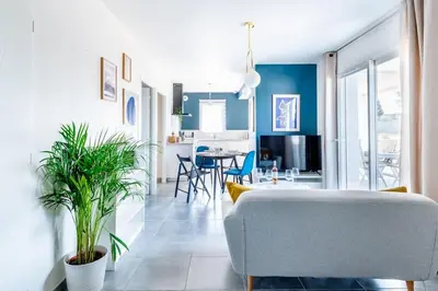 a living room with a couch and a dining room at ☆ Blue Provençal Appartement ☆ in Morières-lès-Avignon