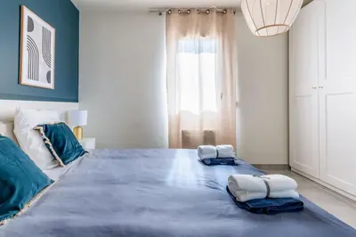 a bedroom with a large bed with two pillows on it at ☆ Blue Provençal Appartement ☆ in Morières-lès-Avignon