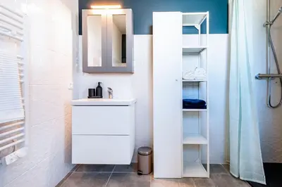 a white bathroom with a sink and a mirror at ☆ Blue Provençal Appartement ☆ in Morières-lès-Avignon