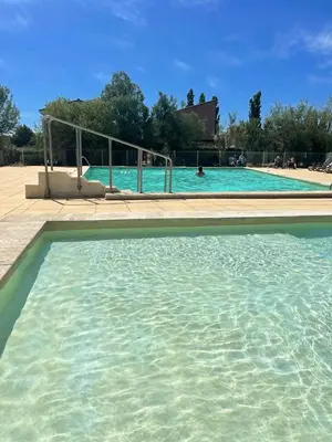 a large swimming pool with blue water at Maison confortable Saint-Saturnin in Saint-Saturnin-lès-Avignon