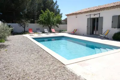 a swimming pool in the backyard of a house at charming vacation rental with heated pool at the foot of the alpilles, in aureille, close to the center of the village on foot, sleeps 6/8 people in provence. in Aureille
