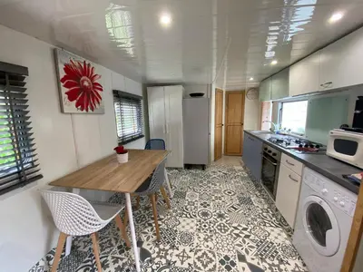 a kitchen with a table and chairs in a kitchen at Chalet de Provence in Aix-en-Provence