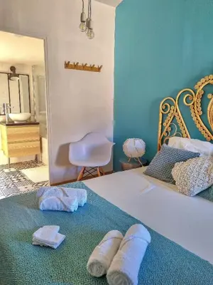 a bedroom with a bed with two towels on it at Un balcon sur les toits d'Aix in Aix-en-Provence