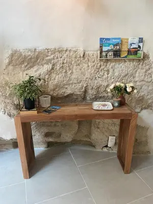 a wooden table with potted plants on a wall at Bonnieux : Loft - La pause in Bonnieux