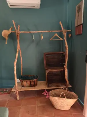 a room with two baskets and a shelf with a fan at chambre d'hôtes Et Puis Voilà! in Murs