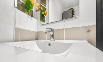 a bathroom with a white sink and a mirror at Les Amandiers - L'Isle d'Or in LʼIsle-sur-la-Sorgue