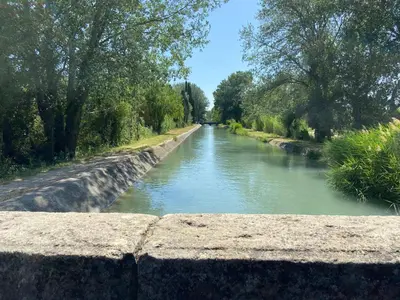 a view of a river from a stone wall at L’oliveraie in Robion en Luberon