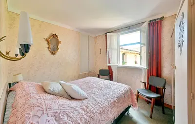 a bedroom with a bed with two pillows and a window at Gorgeous Home In Bédoin With Wifi in Bédoin