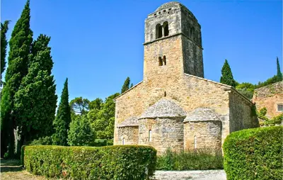 an old stone church with a tower and some bushes at Gorgeous Home In Bédoin With Wifi in Bédoin
