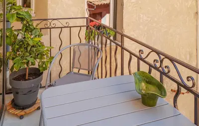 a white bench sitting on a balcony with a plant at Gorgeous Home In Bédoin With Wifi in Bédoin