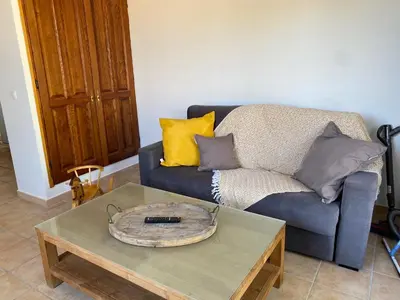 a living room with a blue couch and a coffee table at Les Célestins - Villa en Provence in Carpentras