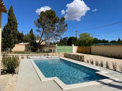 a swimming pool in the backyard of a house at Les Célestins - Villa en Provence in Carpentras