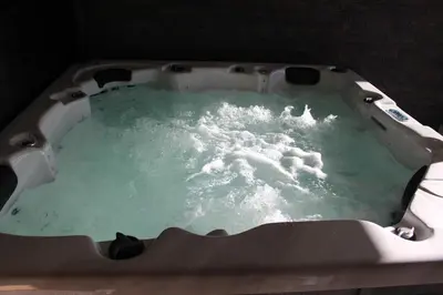 a bath tub filled with green water in at Maison avec piscine, jacuzzi et sauna privatifs - Mas de Nebbas in Aix-en-Provence