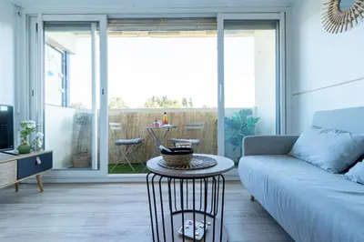 a living room with a couch and a table at Studio cosy à proximité du centre ville in Aix-en-Provence