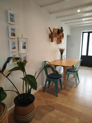 a dining room with a table and a potted plant at A l'Ombre de la Dame in Cucuron