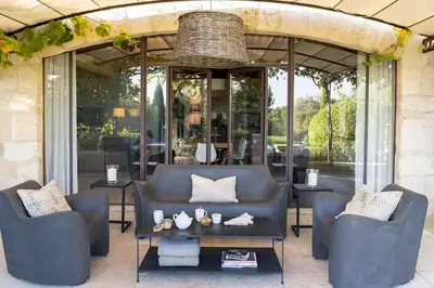 a patio with a couch and chairs and a table at Mas De Rosemarie in Joucas