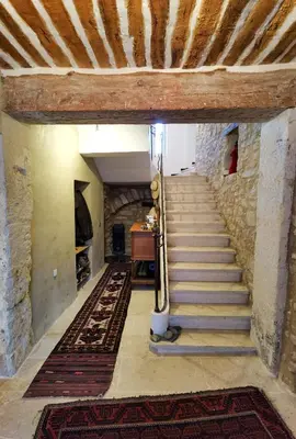 a staircase in an old building with a wooden ceiling at Romantic Provencal house with terrace in Saignon