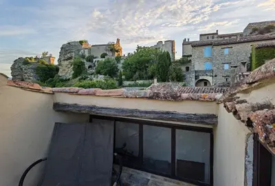 a view of a castle from the roof of a building at Romantic Provencal house with terrace in Saignon