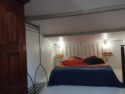 a bedroom with a large bed with aighed sqor at Chambre d’hôtes l’Orange Bleue in Rustrel