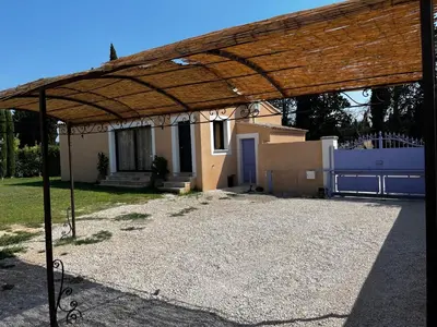 a wooden pavilion in front of a house at Magnifique maisonnette Dépendance avec Piscine in Châteaurenard
