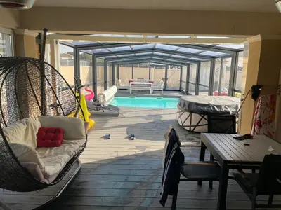 a porch with a hammock and a swimming pool at L'Aurore Love Room de prestige jacuzzi sauna piscine chauffée cuisine in Carpentras