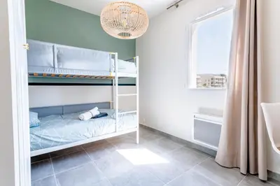 a bedroom with bunk beds and a window at Havre de nature Provence in Morières-lès-Avignon
