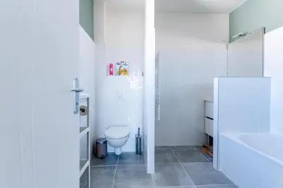 a white bathroom with a toilet and a sink at Havre de nature Provence in Morières-lès-Avignon