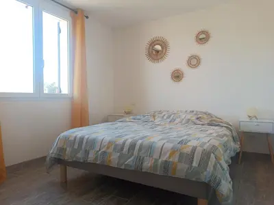 a bedroom with a bed and a window at La Remise de Guytou et Spa in Cheval-Blanc