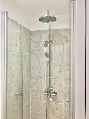 a shower with a glass door in a bathroom at Petit cocoon Aixois in Aix-en-Provence
