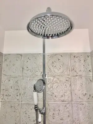 a shower with a shower head in a bathroom at Petit cocoon Aixois in Aix-en-Provence