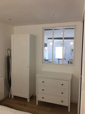 a bedroom with a white dresser and a window at Petit cocoon Aixois in Aix-en-Provence