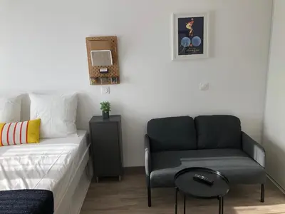 a bedroom with a bed and a chair at Ma place au sud 1 in Éguilles