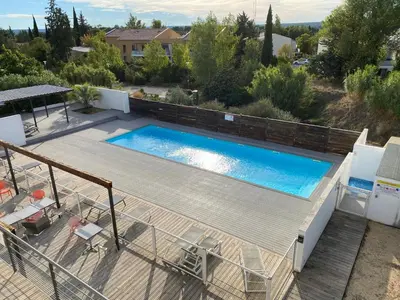 a swimming pool on a deck next to a house at Ma place au sud 1 in Éguilles