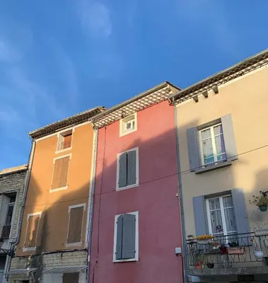 a row of colorful buildings in a city at La Maison Rose in Caromb