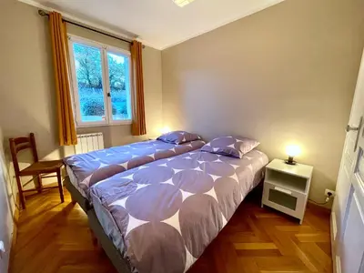 a bedroom with two beds and a window at Villa avec Piscine et Vues Imprenables in Villars