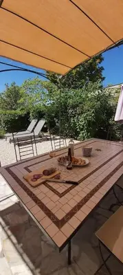 a table with an umbrella on a patio at Bastidon Plein Sud in Gordes
