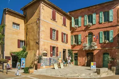 a group of buildings with green shutters on them at Bastidon Plein Sud in Gordes
