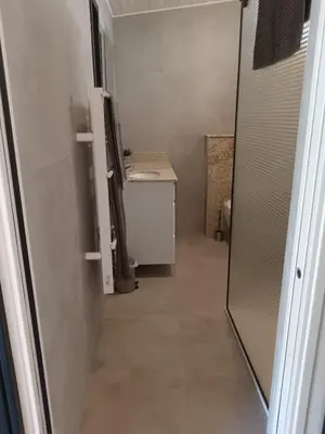 a room with a hallway with a table and a counter at La maison de Marie Hélène 2 piscine partagée in Aix-en-Provence