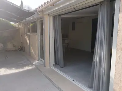 a sliding glass door on the side of a house at La maison de Marie Hélène 2 piscine partagée in Aix-en-Provence