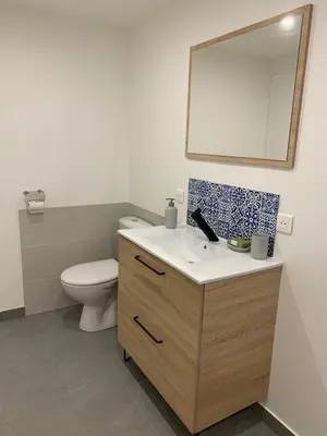 a bathroom with a toilet and a sink and a mirror at Charmant logement avec un extérieur et un jacuzzi in Lançon-Provence